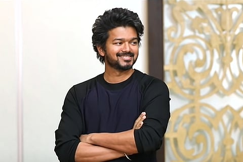 Actor Vijay in a black t-shirt with his arms crossed