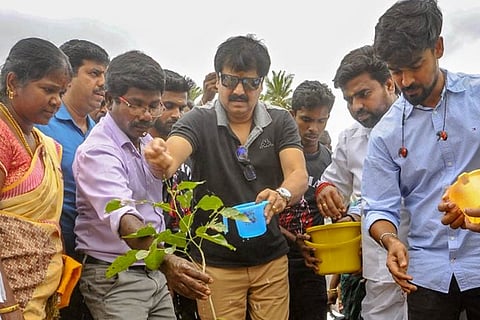Vivek is seen planting saplings along with students.
