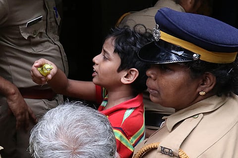 In heartbreaking pics, Kerala boy desperately holds on to pet bird as he loses his home
