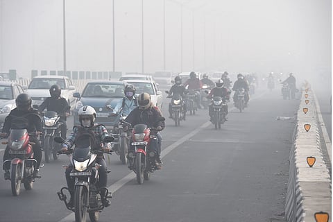 Vehicles ply amid low visibility due to smog in New Delhi