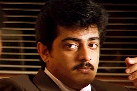 Ajith is seen wearing a brown coat in a screengrab from Tamil movie 'Vaalee'.