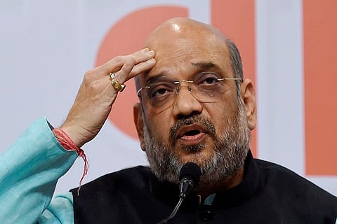 Union Home Minister Amit Shah touching his forehead