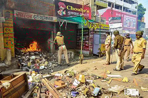 Police douse a fire in Amravati town after vandalism of a store in the town