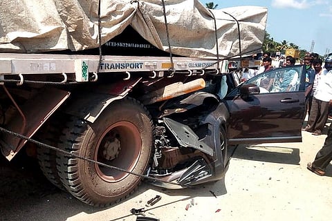 The car first hit a two wheeler before hitting a truck parked on the roadside.