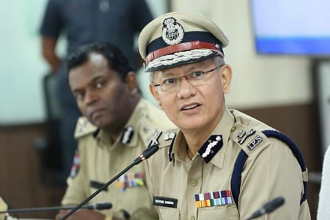 Andhra DGP Gautam Sawang with his head tilted towards the left as he addresses a gathering