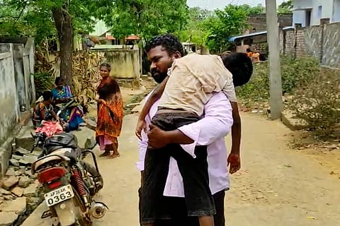 Andhra man carrying the body of his son