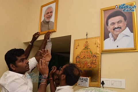 Tamil Nadu BJP chief Annamalai hanging a portrait of PM Narendra Modi inside a ration shop in Coimbatore