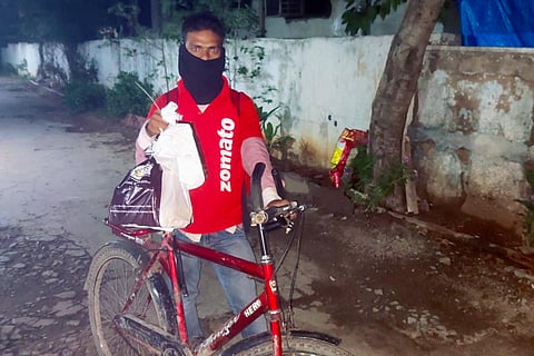 Mohd Aqeel with his bicycle when he came to deliver the order