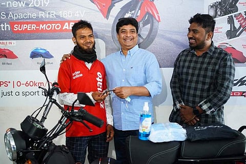 Aqeel standing with his new bike