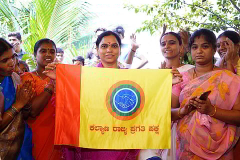 Aruna Lakshmi holding flag
