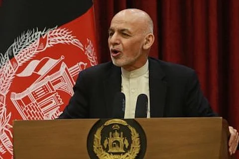 Afghanistan President Ashraf Ghani stands before a podium