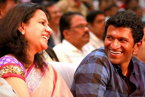 A beaming Ashwini Puneeth Rajkumar sitting next to her husband Puneeth Rajkumar
