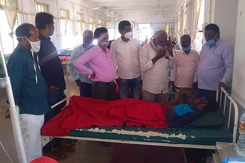 Basava at the hospital surrounded be several people