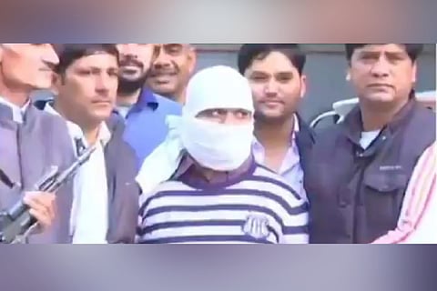 Ariz Khan, convict in the Batla House encounter case, seen with a white cover on his face flanked by officials
