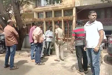 Police and other people standing in front of the building where prayer was being conducted