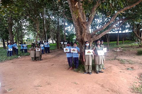 The students of the government high school hugging the trees