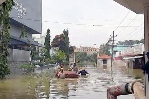 Residents being pulled out of their inundated homes by rescue teams in Bengaluru