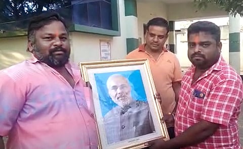 Bhaskaran and other BJP members who hung the PM's photo in a Town Panchayat office in Coimbatore