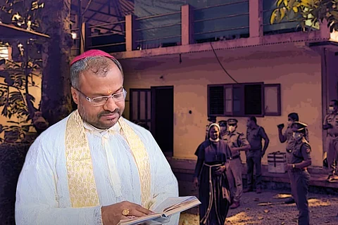 Bishop Franco Mulakkal looks at a book in the foreground, while a nun and police officers can be seen in the background