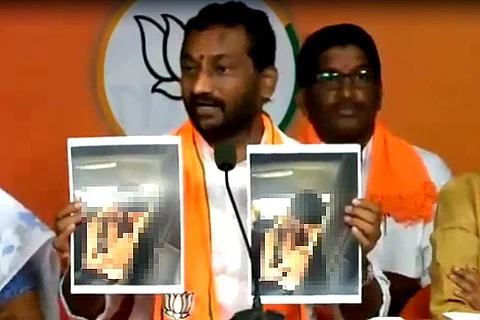 BJP MLA Raghunandan Rao showing photos of the Hyderabad gangrape survivor in the car