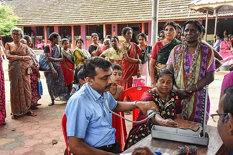 Flood affected people in Kerala queue up for health check-up at a relief camp in Kochi in 2018