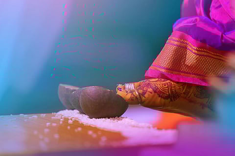 Bride kicking coconut and rice