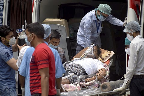 Patient on oxygen support being taken into the hospital