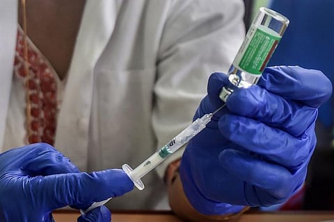 Healthcare worker drawing COVID-19 vaccine