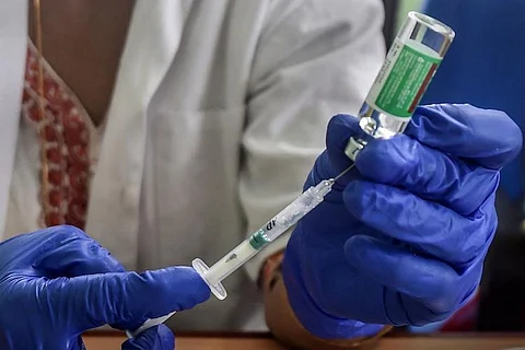 A health care worker holding a vaccine
