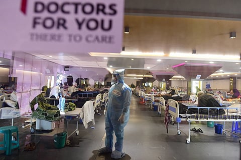 A health worker inspects COVID-19 patients at an isolation centre in New Delhi.