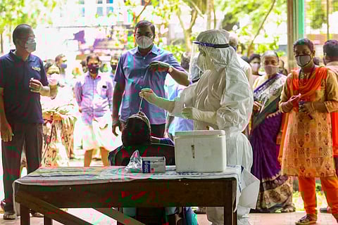 Health workers take swab samples for COVID-19 testing as coronavirus