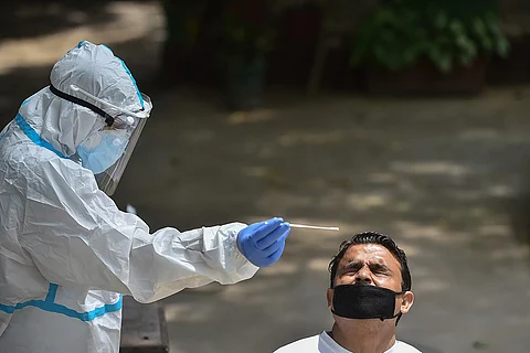 Health worker collecting swab from a man