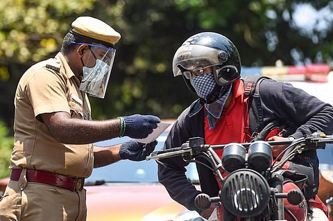 A police man checking the documents of a motorist