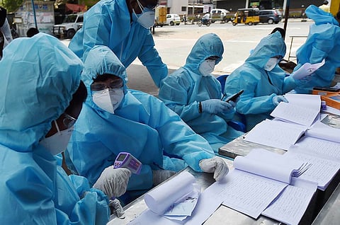 Workers in PPE suits