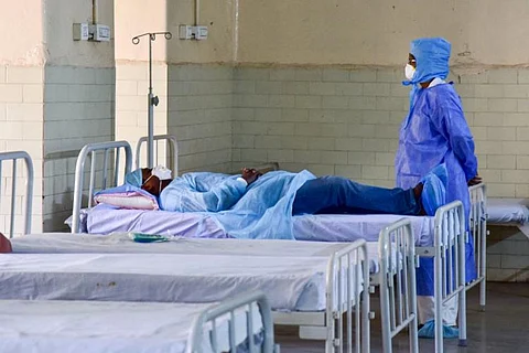 A medical professional with COVID-19 patient