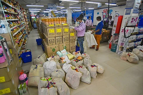 Workers of a grocery store preparing packets for home delivery