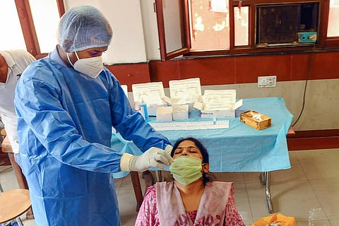 A health worker collecting a woman's sample for COVID test: Telangana High Court directed government to ramp up RT-PCR testing