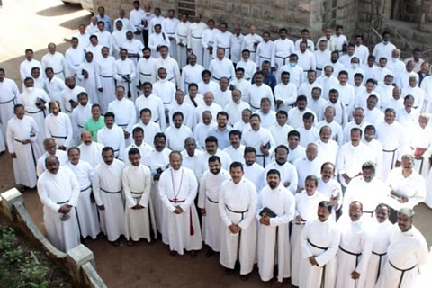 A congregation of CSI priests in Kerala dressed in white
