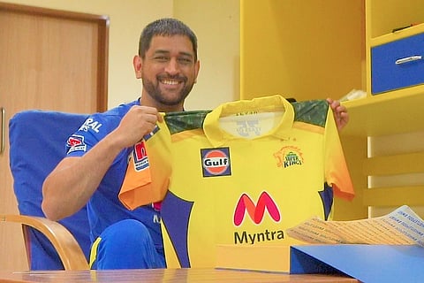 Dhoni holding up CSK new jersey