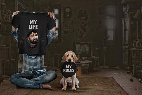 A poster from 777 Charlie with Rakshit Shetty