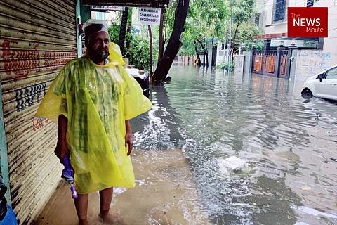 A resident standing on the side of a waterlogged street in Chennai's Seethammal Colony after heavy rains