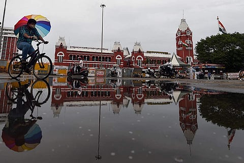 Chennai: Central Railway Station is reflected in the rainwater collected on a road
