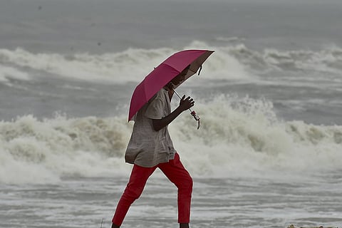 A woman enjoying the cloudy skies in beach