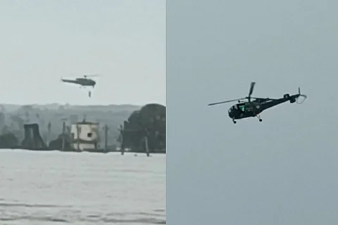Two images showing the NDRF helicopter airlifting two from a water tank amid the flood.