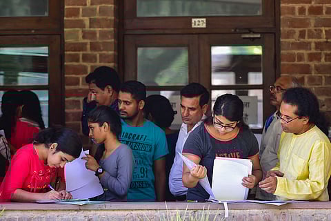 Students with application forms during college admissions