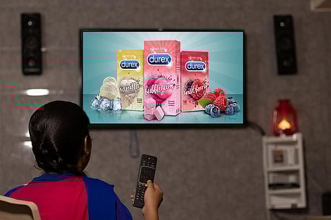 Child watching tv playing condom ad