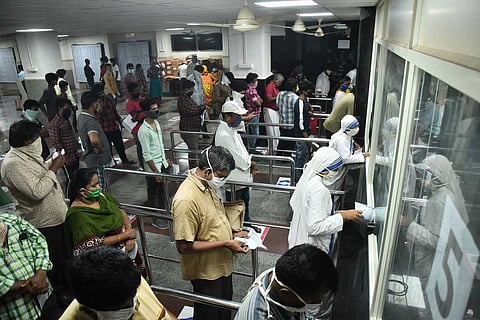 People standing in queues at counters