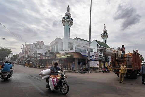 A man transporting huge sacks on his two-wheeler on a Chennai road