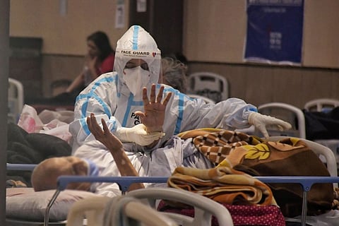 A COVID19 patient being treated my a medical staff wearing PPE kit in India inside a hospital