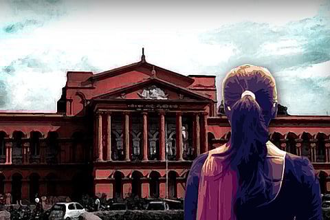 Woman standing before court with her back to the camera